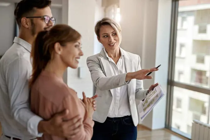 Smiling Real Estate Agent Talking With Couple Interested Buying New Home X - Certified Mortgage Advisor study guide