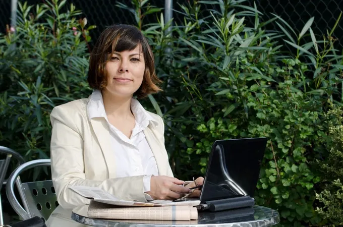 Female White Suit Sitting Table With Her Laptop Near Green Bushes X - Certified Nonprofit Executive study guide