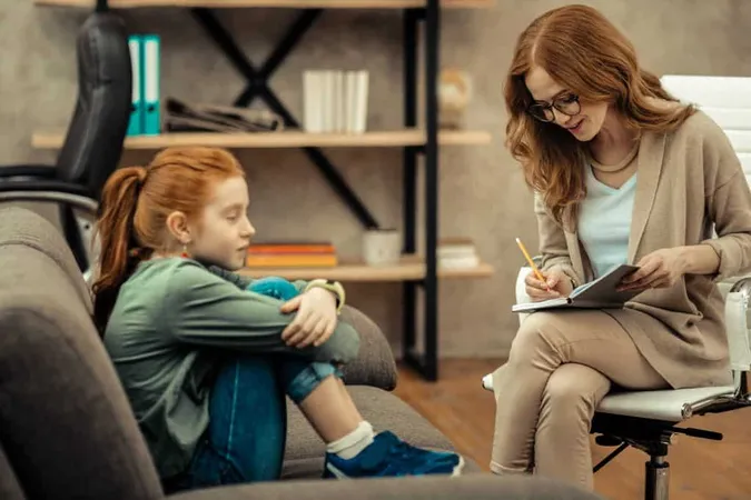 Professional Consultation Nice Friendly Psychologist Sitting Near Her Patient While Taking Notes Notebook X - Certified School Counselor study guide